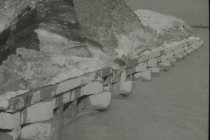 Snow piled up on long concrete pier